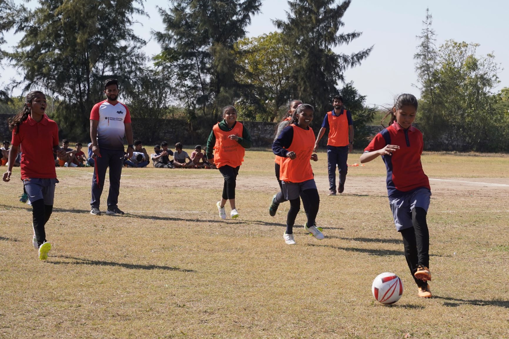 Young women playing soccer at a sports and youth festival at a local school in the region of Rapar, Gujarat, India, promoting educational and sports opportunities for youths.