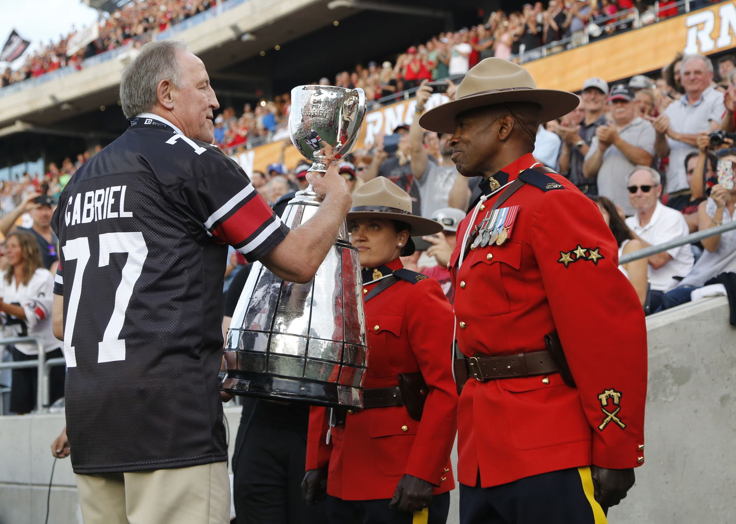 The Grey Cup makes its way onto the field at TD Place.