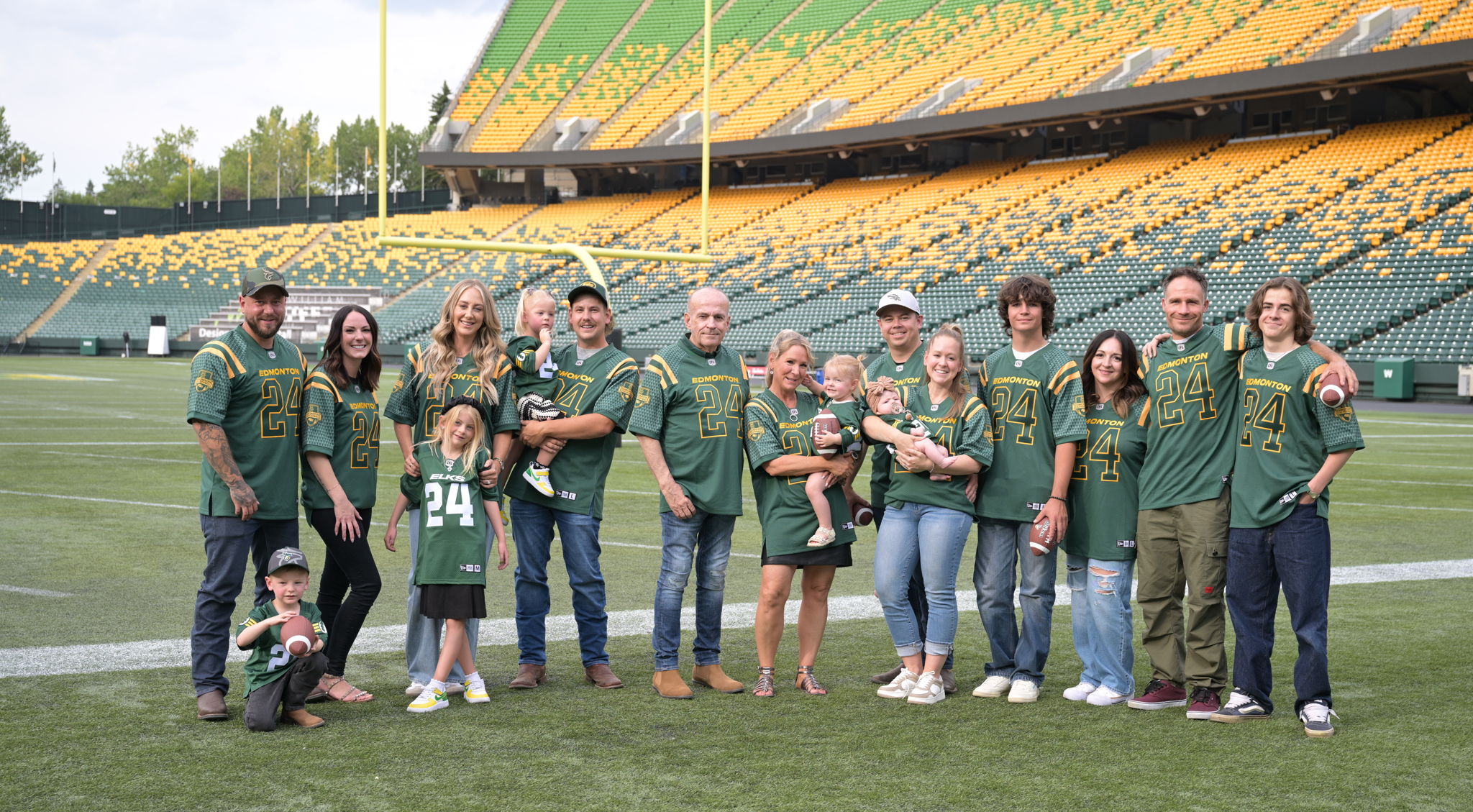 Larry and Deb Thompson (centre) pictured with the rest of the Thompson family at Commonwealth Stadium.