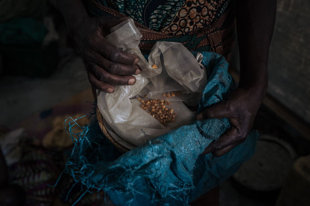 Agrippine, a 53-year-old displaced widow, holds the last remaining corn to feed her family, at the informal IDP site of Rugabo Stadium in Rutshuru Centre, in North Kivu province, eastern Democratic Republic of Congo. She and six of her ten children fled their village because of clashes between the Congolese army and the M23 armed group. She has no news of her other four children. Photographer: Alexis Huguet