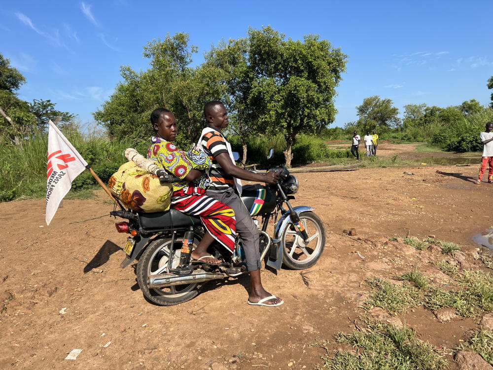 A woman and her baby are transported by MSF motorcycle back to their village after treatment. Batangafo, Central African Republic. August 2023. Copyright: Max Landry Kassaï/MSF