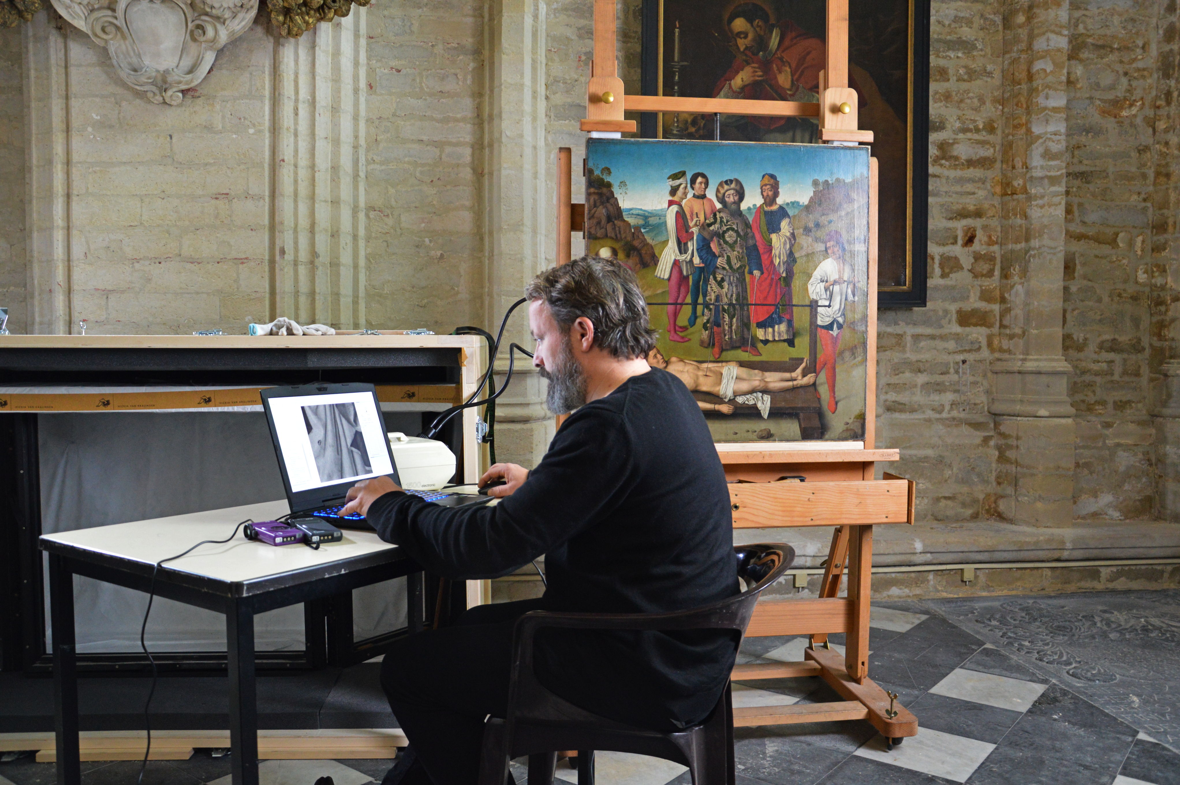 David Lainé bestudeert een detail van 'De Marteling van de Heilige Erasmus'. foto: © David Somers