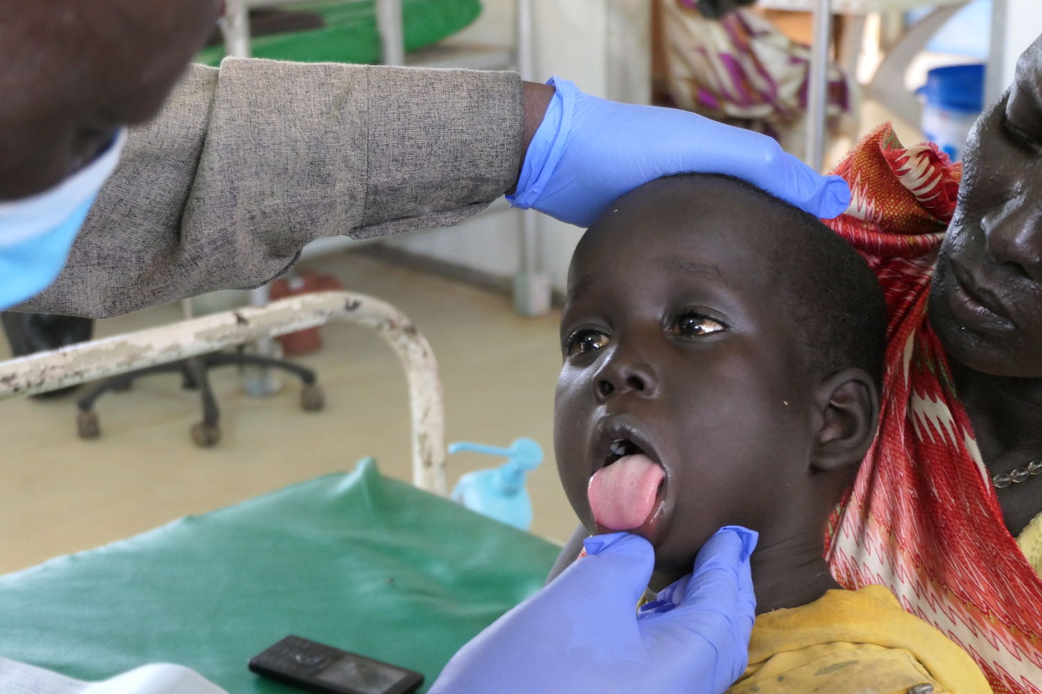 Kang Gatlok, 4 years old, during a medical consultation in which he tested positive for hepatitis E. The disease is most commonly spread through ingestion of water or food contaminated by an infected person’s faeces. Each individual in his family has access to around 5L of clean water per day – one-third of the minimum international standard required to ensure healthy conditions. Copyright: Damaris Giuliana/MSF