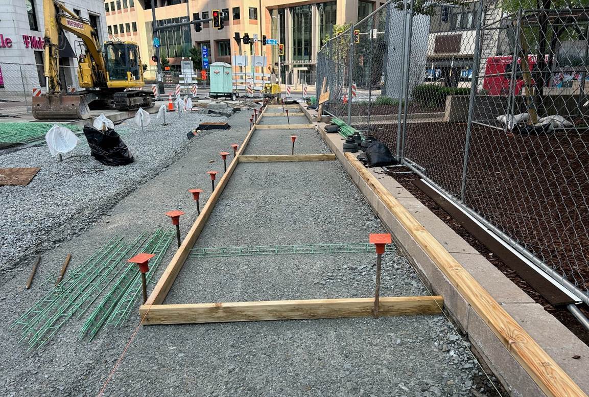 A wood frame was placed in preparation for new sidewalks to be poured inside the work zone on Fifth Avenue between Market Street and Liberty Avenue A wood frame was placed in preparation for new sidewalks to be poured inside the work zone on Fifth Avenue between Market Street and Liberty Avenue