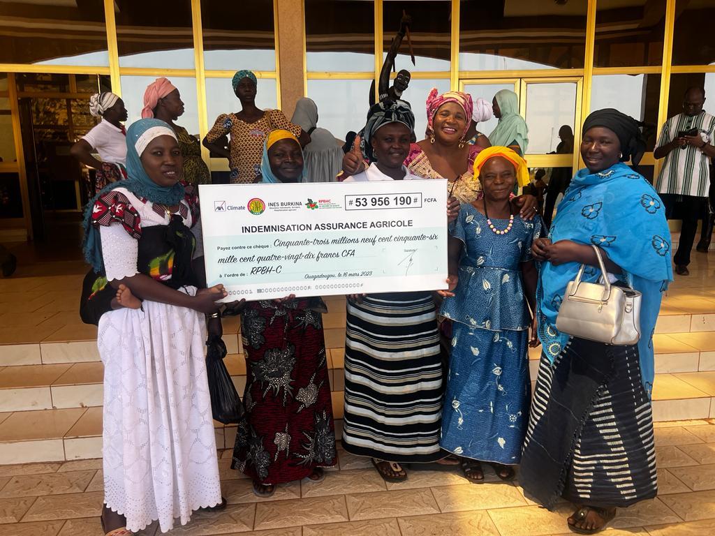 Members of a Women's Association display their community savings