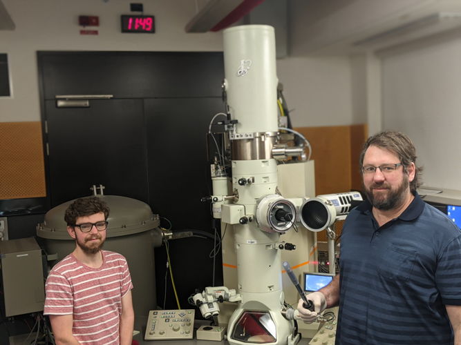 PhD scholar Brenton Cook (left) and Prof Dougal McCulloch with one of the electron microscopes used in the research. Credit: RMIT