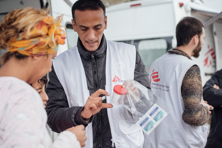 MSF Cultural Mediator Lofti Jenboudi talks to a patient on Lesbos, 8 January 2018. Credit Kevin McElvaney/MSF,