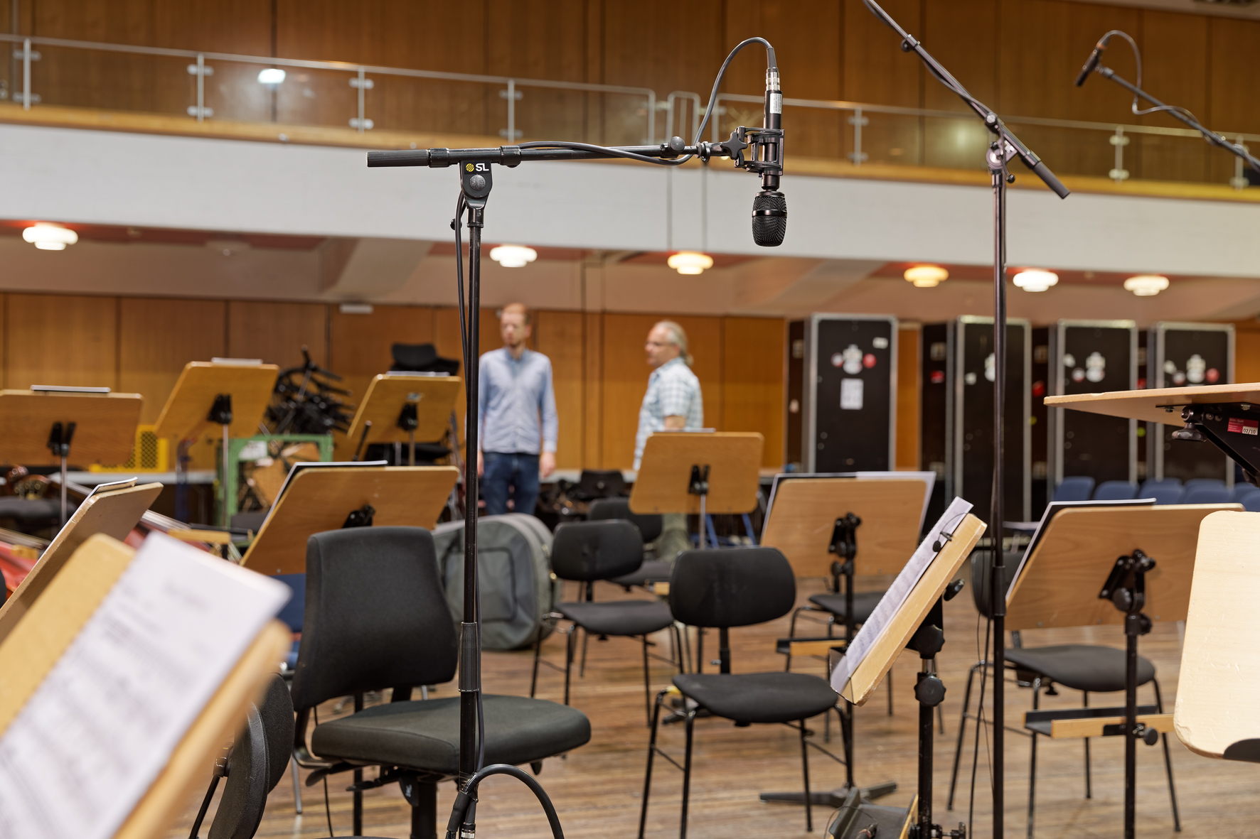 By carefully positioning the microphones, the acoustic deficiencies of the hall were compensated for