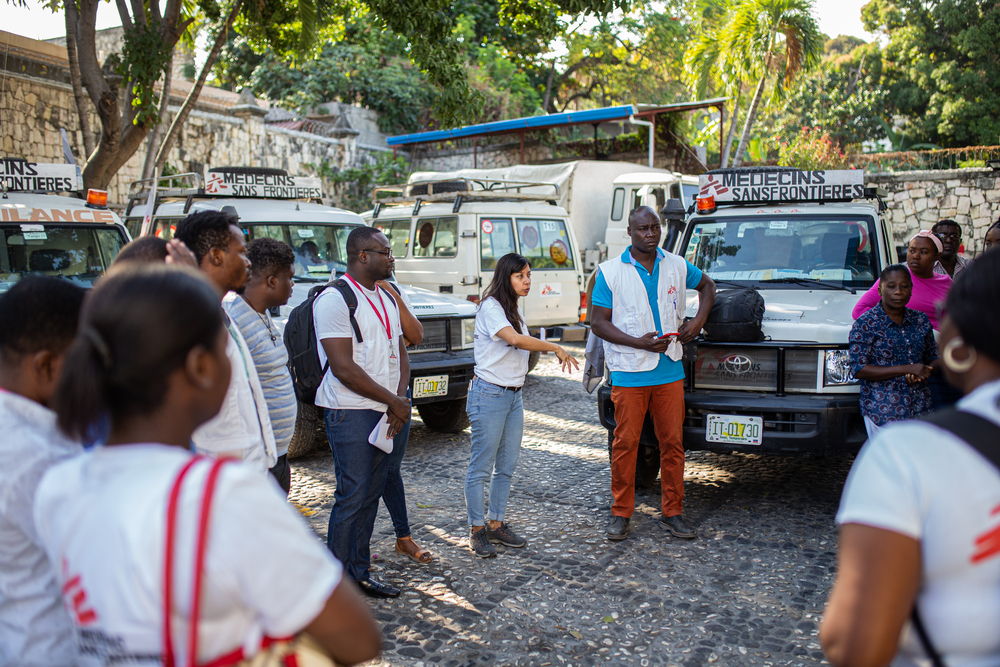 The mobile clinic team receives a briefing from MSF project coordinator Diana Manilla Arroyo and MSF medical referent Roger Ngueremi in front of the MSF office located in Delmas 48 before leaving to Bel Air, a neighborhood located in the center of Port-au-Prince. The team brainstorms about the priorities of the day, security updates and potential challenges. | Date taken: 28/02/2023 | Photographer: Alexandre Marcou | Location: Haiti