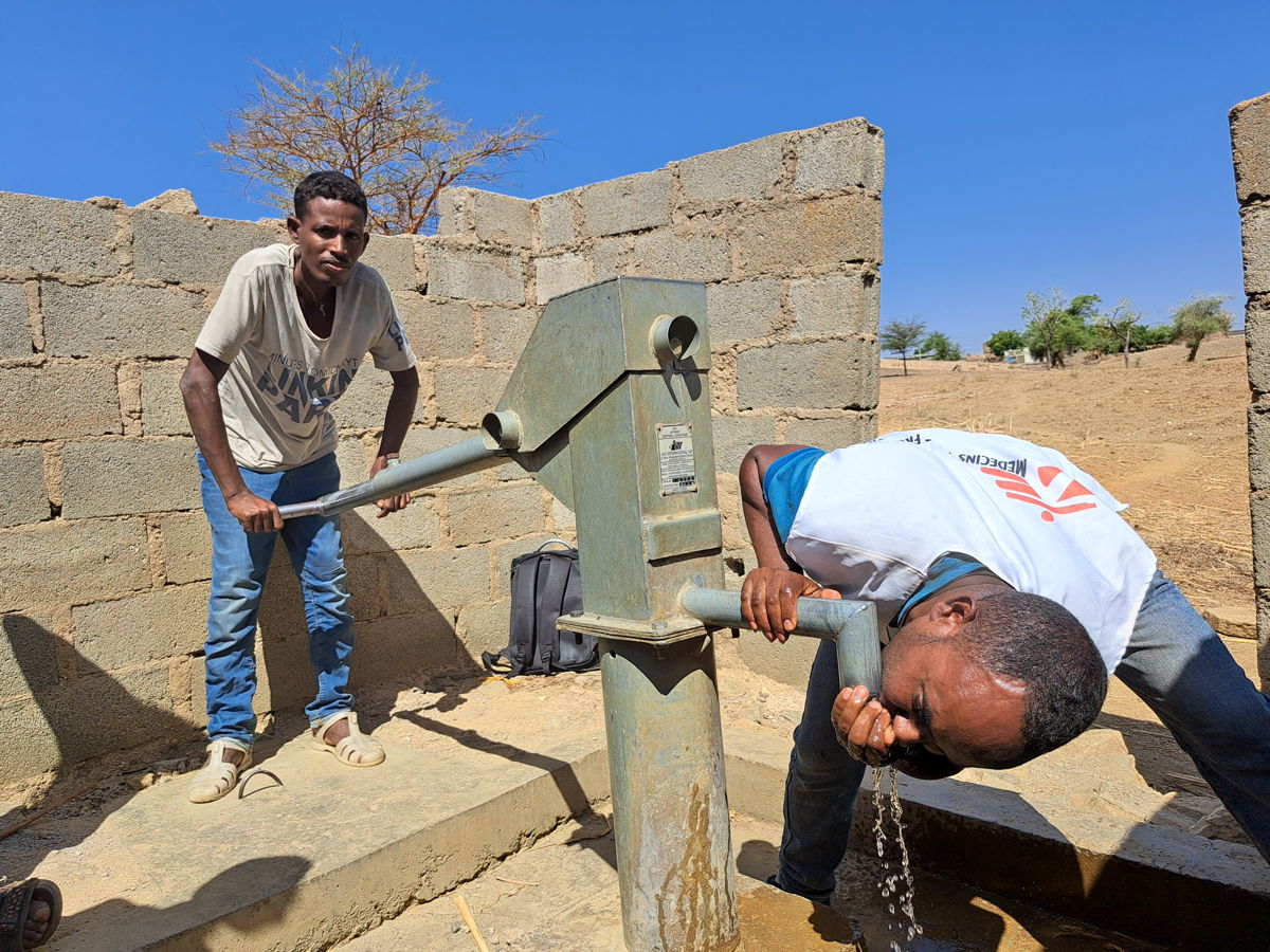 Weldekiros Assefa is an engineer and MSF’s water and sanitation expert. Together with Murra Omleca, a member of the water committee and a representative of the rural water authority, he is checking the repair of four hand-pumps in May Kwait, a small village an hour’s drive from Shire where, thanks to MSF’s donation of spare parts, people can drink clean water out of the wells again. Photographer: Gabriella Bianchi. Date: 15/05/2023. Location: Ethiopia