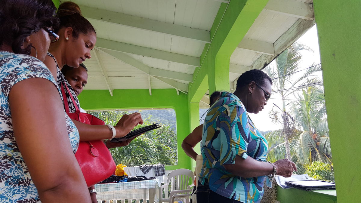 OECS Statistical Services Unit (SSU) and St. Lucia's Central Statistical Office (CSO) staff members conducting a survey with the use of tablets.