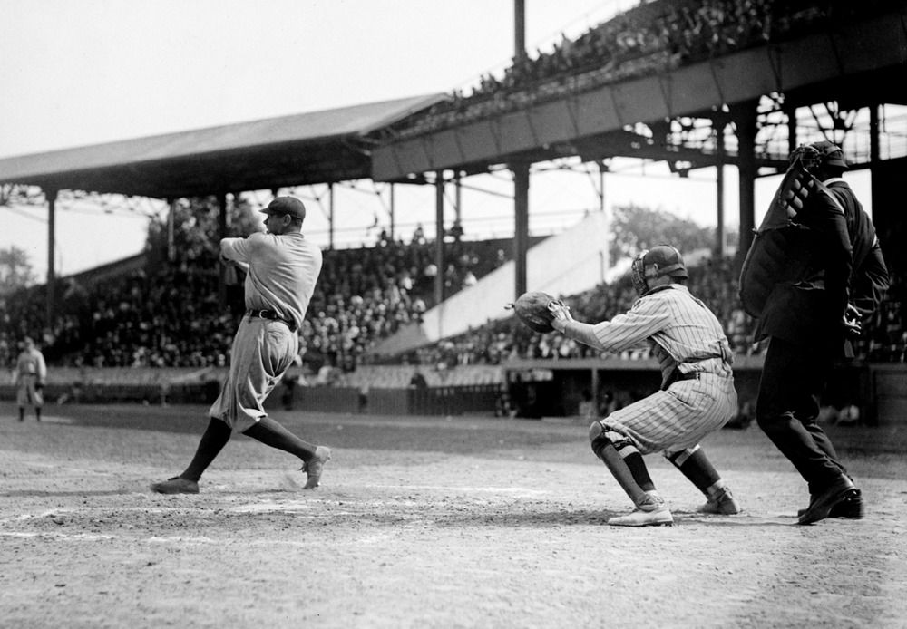 Entitled: "Babe Ruth at bat, Garret catching." George Herman "Babe" Ruth, Jr. (February 6, 1895 - August 16, 1948) was an American baseball player who spent 22 seasons in Major League Baseball (MLB) playing for three teams (1914-1935). He originally entered the major leagues with the Boston Red Sox as a starting pitcher, but after he was sold to the New York Yankees in 1919, he converted to a full-time right fielder. He subsequently became one of the league's most prolific hitters and with his home run hitting prowess, he helped the Yankees win seven pennants and four World Series titles. Ruth retired in 1935 after a short stint with the Boston Braves, and the following year, he became one of the first five players to be elected into the National Baseball Hall of Fame. He is regarded as one of the greatest sports heroes in American culture. He died on August 16, 1948, of cancer at age 53. Photographed by National Photo Company, 1920. AKG5464002 © akg-images / Science Source