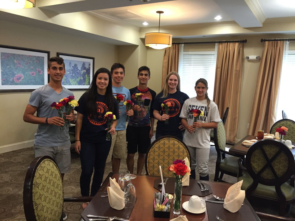 Students at Seven Lakes High School in Texas help out a local senior home during Flower Power.