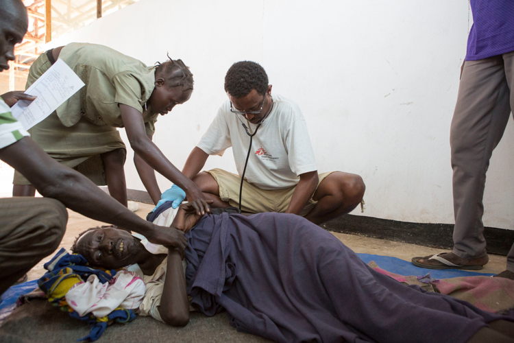 Bume Pal, 45 is pictured getting examined by a doctor in Pugnido health post after suffering from mental illnesses. He had been seen three months before and was diagnosed but refused to take medicine. His son Chang Koth is who is responsible for care. The family came in 2015 from Jonglei state and has been in Pugnido since then. Photographer: ZACHARIAS ABUBEKER Bume Pal, 45 is pictured getting examined by a doctor in Pugnido health post after suffering from mental illnesses. He had been seen three months before and was diagnosed but refused to take medicine. His son Chang Koth is who is responsible for care. The family came in 2015 from Jonglei state and has been in Pugnido since then. Photographer: ZACHARIAS ABUBEKER
