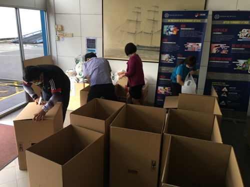 Colleagues in Singapore wrapping up donations to be sent to St. John’s Home for Elderly Persons.