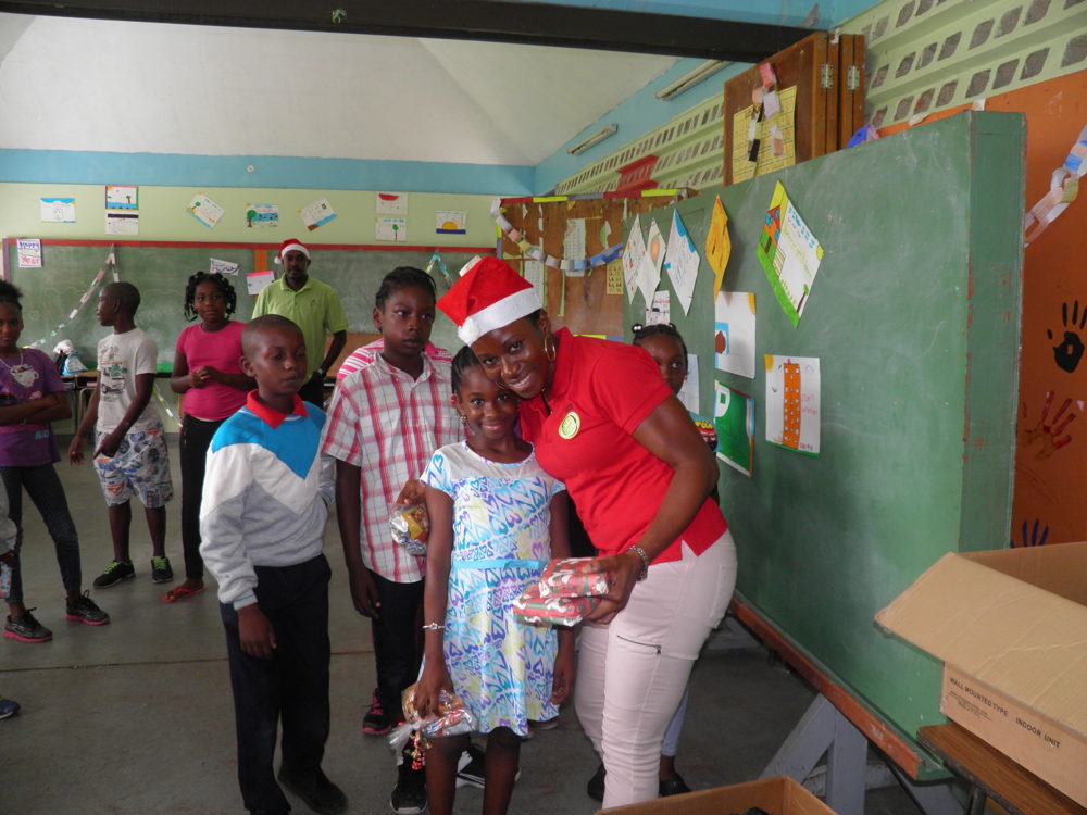 OECS Staff distributing gifts during the Toy Drive to Dominica.