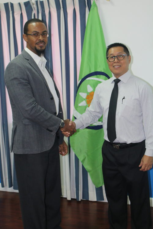 Programme Officer in the Trade Policy Unit at the OECS Commission, Mr. Cosbert Woods, with Captain Mark Heah of ST Electronics.