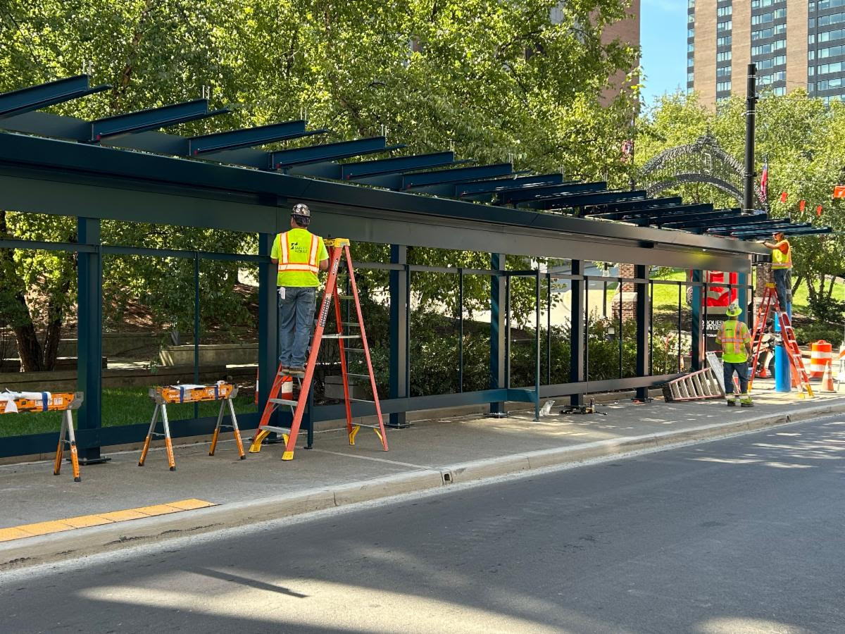 Crews install the shelter roof located on Forbes Avenue at Duquesne University