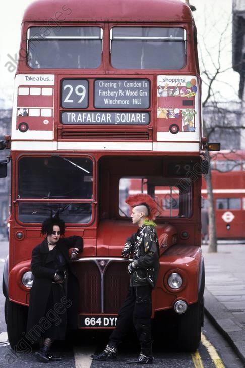 Two punks stood next to a Routemaster bus, London. AKG6119183
