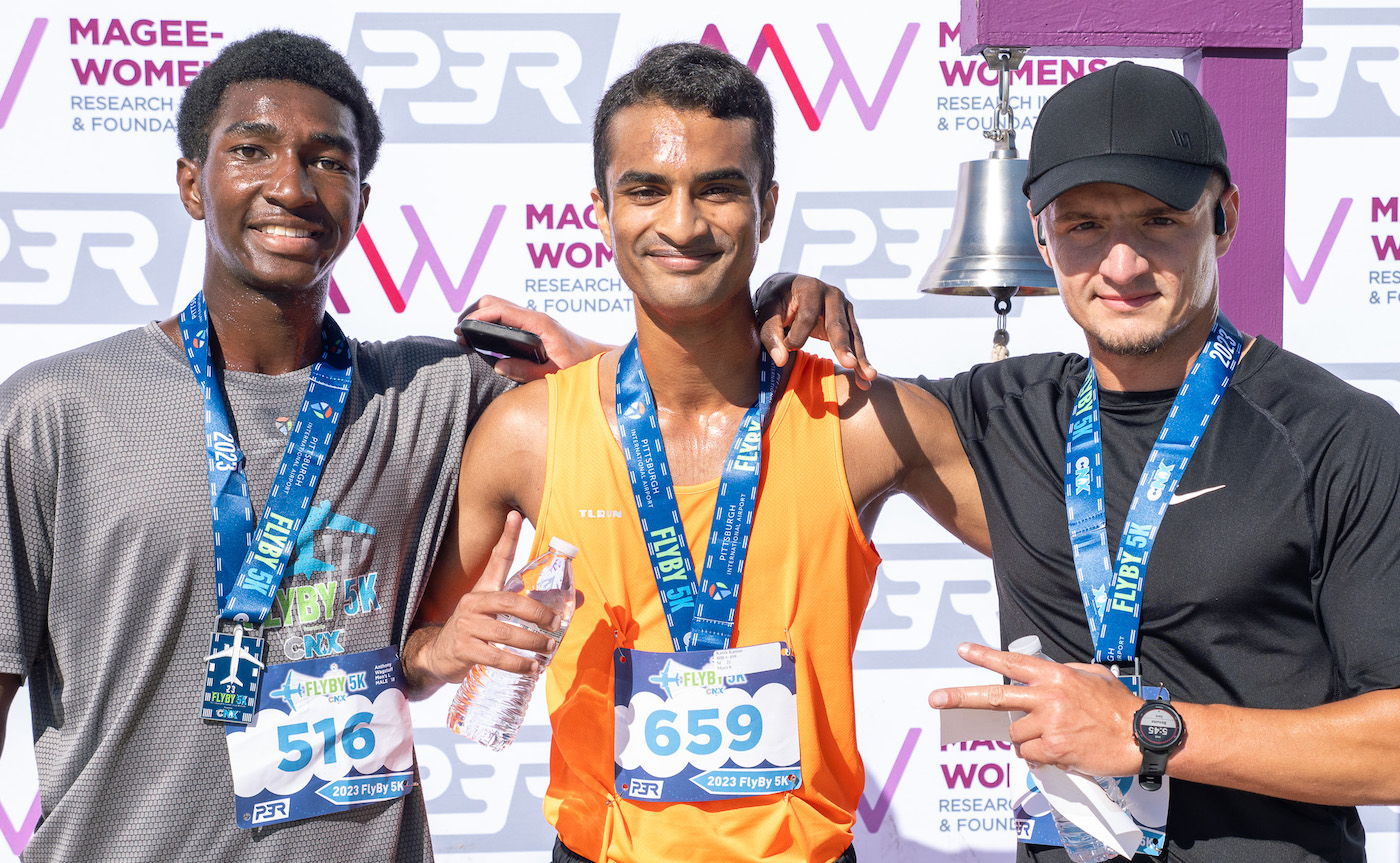 First place finisher Kartik Kannan joins second place Adam Wiltse (right) and third place Anthony Wagstaff (left) after the race. Above, women's winner Jennifer Bigham breaks the finishers tape held by Hayley Scott.