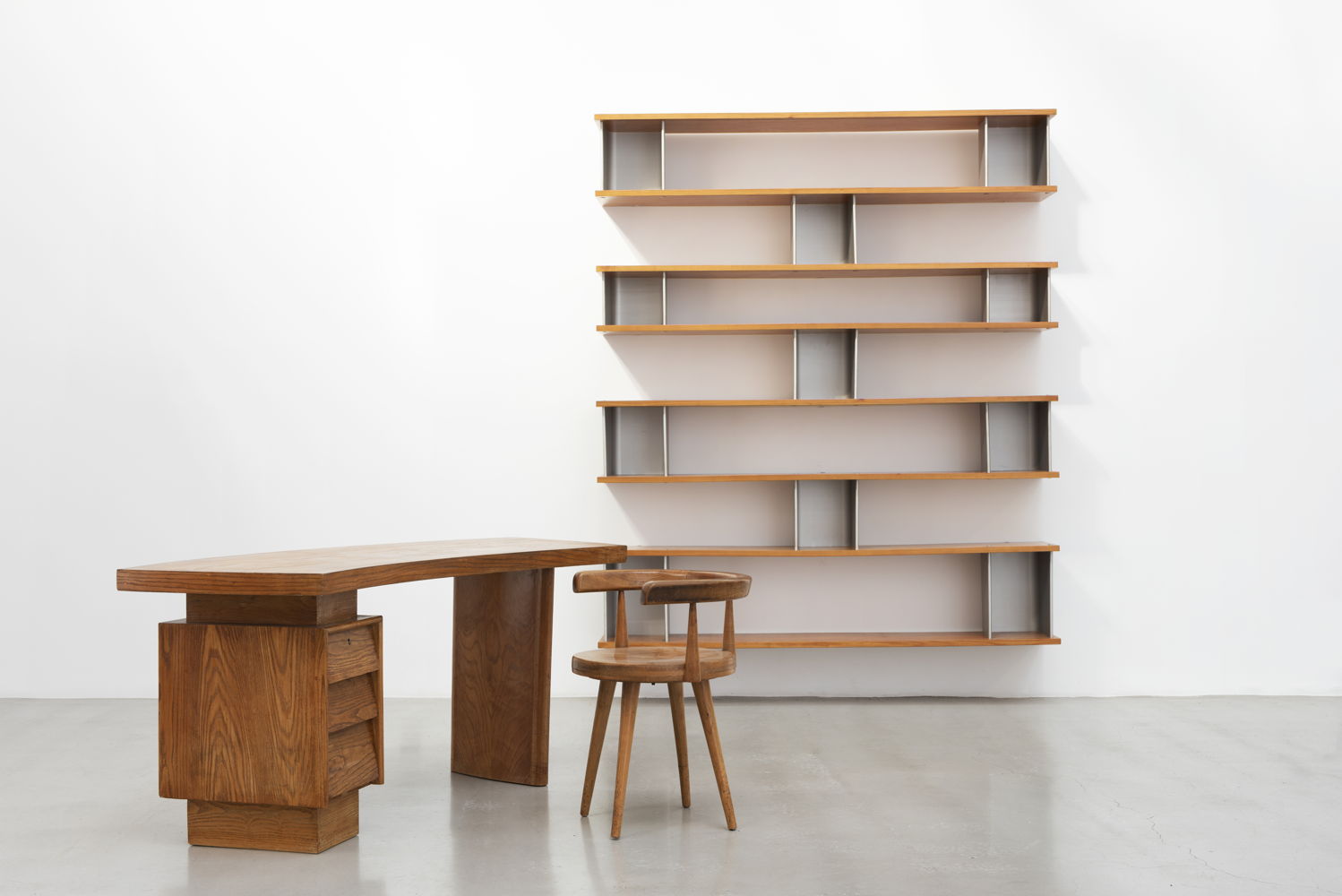 Asymmetrical wall-mounted bookshelves, 1958 by Charlotte Perriand; Desk, 1953 by Pierre Jeanneret; Swiveling Office Chair, 1953 by Pierre Jeanneret and Charlotte Perriand; at Patrick Seguin. Image courtesy of Patrick Seguin