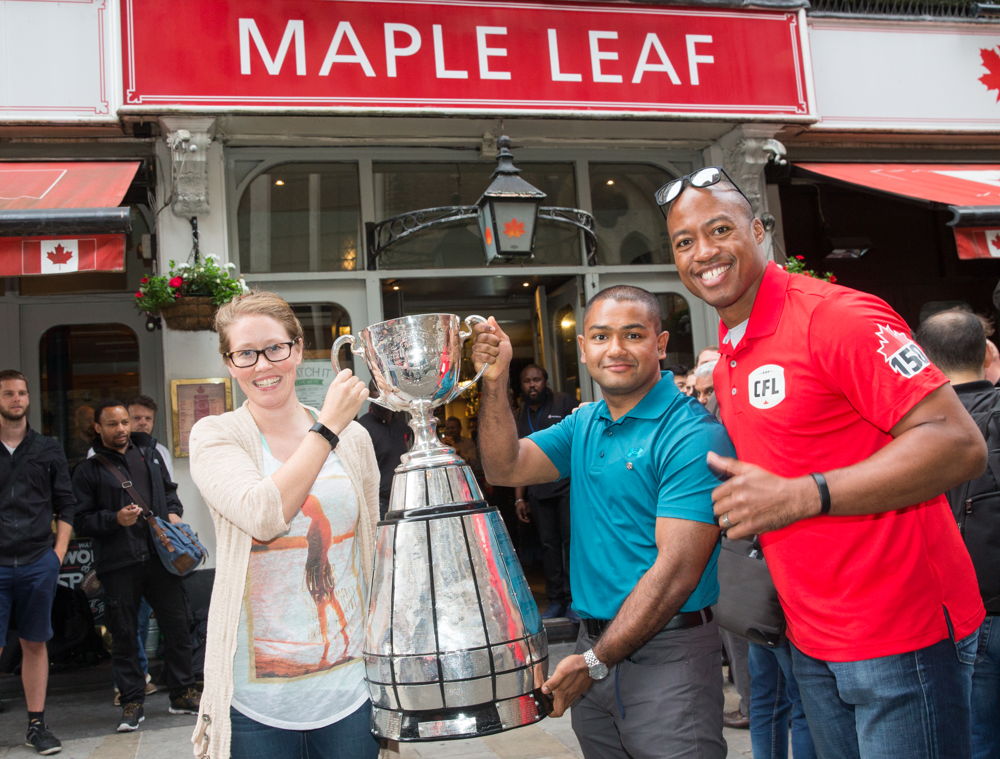 Master Seaman Smallwood, Master Seaman Kyaw Myint and Henry Burris outside the Maple Leaf Sports Bar and Grill. Photo Credit: Jim Ross/CFL