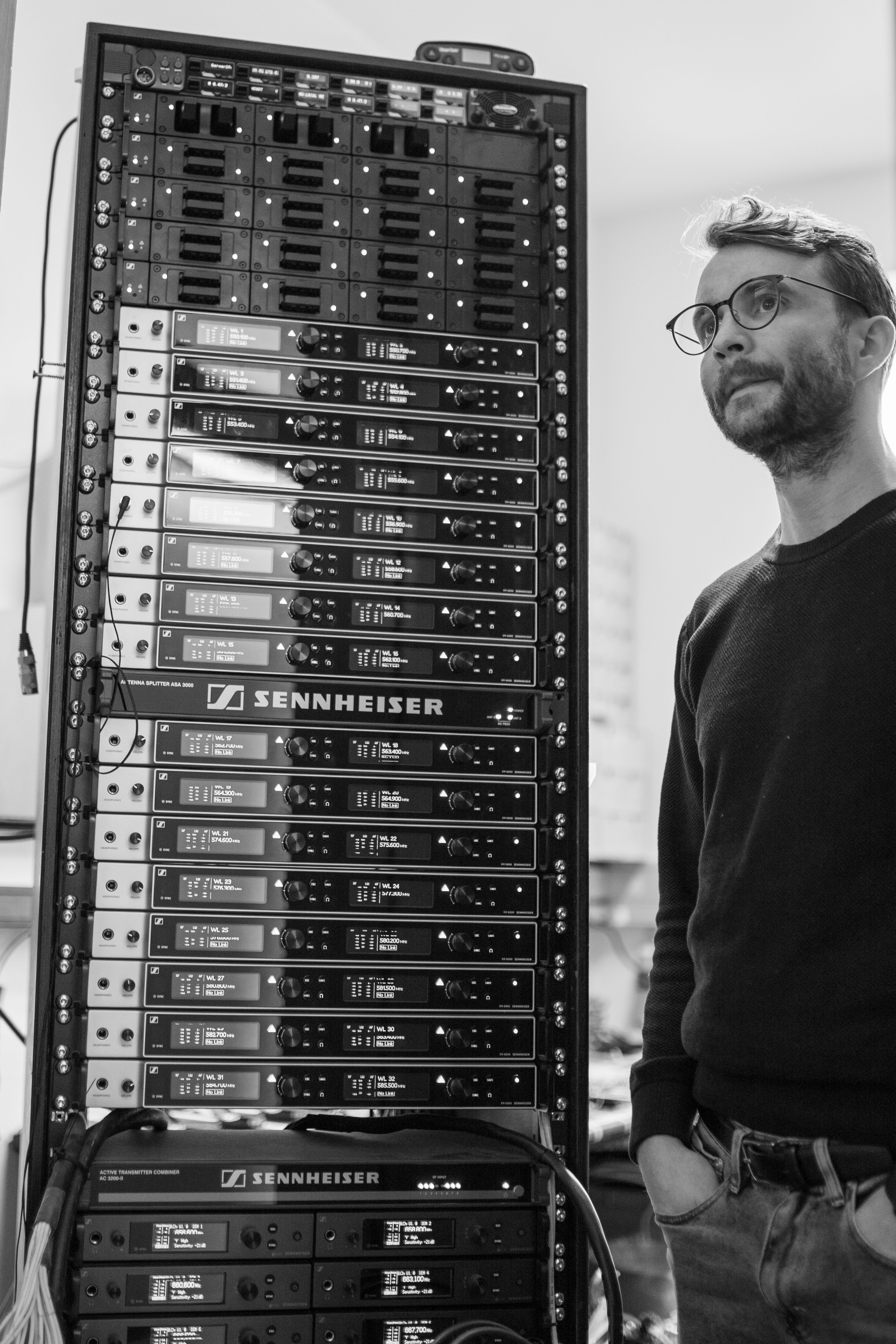 Kristinn Gauti Einarsson, Head of Sound at the National Theatre of Iceland, next to the Sennheiser Digital 6000 racks. At the top: L 6000 charging units, which can be fitted with the respective inserts for all transmitters in the Digital 6000 series