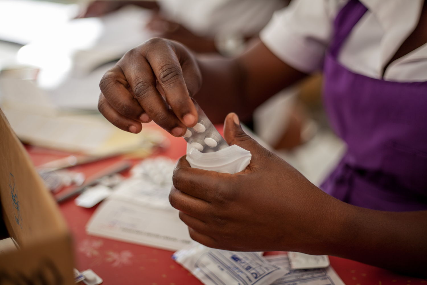 A Harare City Council nurse prepare a typhoid treatment package for a patient. Phot5ographer: Charmaine Chitate