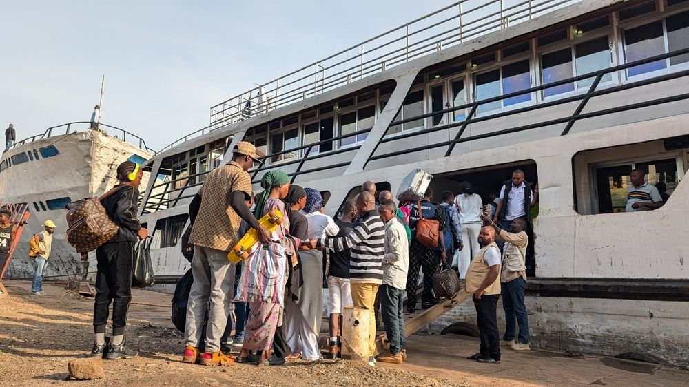 People jump on a ship at the port of Bukavu, capital of South Kivu province, eastern Democratic Republic of Congo. Some navigation through Lake Kivu was restablished today 18 February 2025 | Date taken: 18/02/2025 | Photographer: Amani Alimasi | Location: Bukavu, ​ DRC