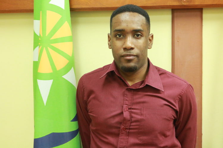 Youth Officer at the OECS Commission, Nyus Alfred, delivers remarks.