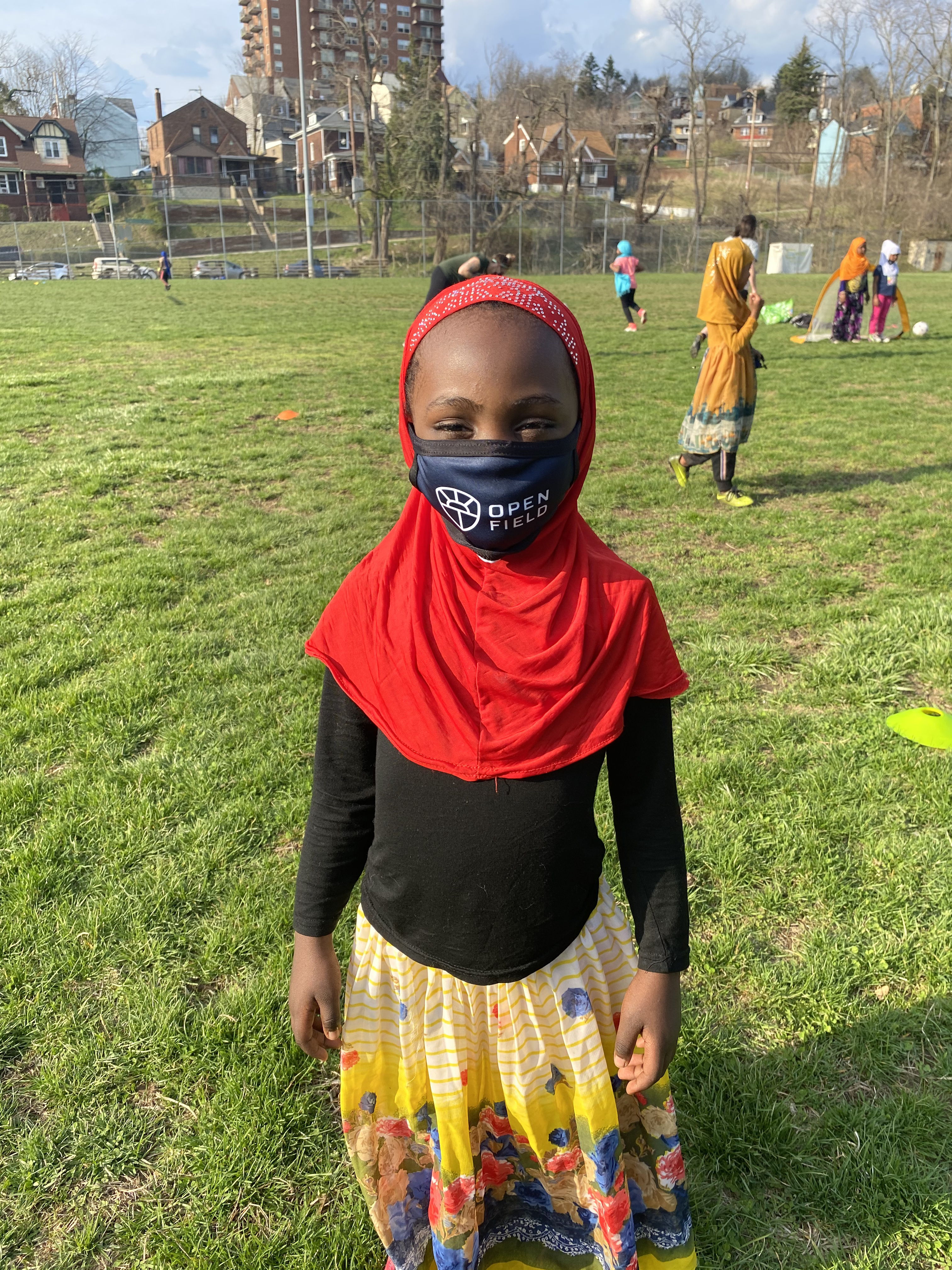 A youngster in a facial covering poses for a photo during one of Open Field's sessions. (Open Field)