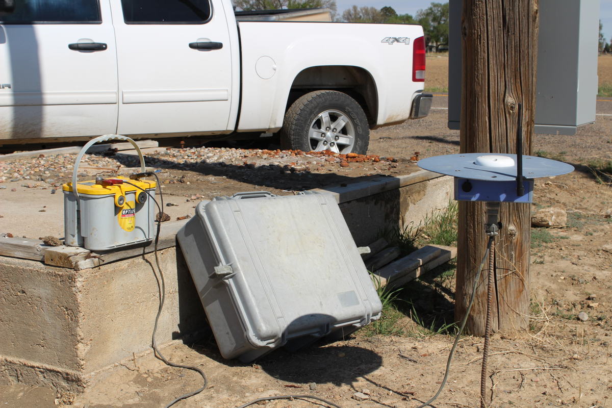 A GPS receiver sits at the edge of a field to help guide the tractor along each row of melons. The satellite-guided technology prevents damage to the drip lines, row coverings, and seedlings, and saves on diesel fuel. 