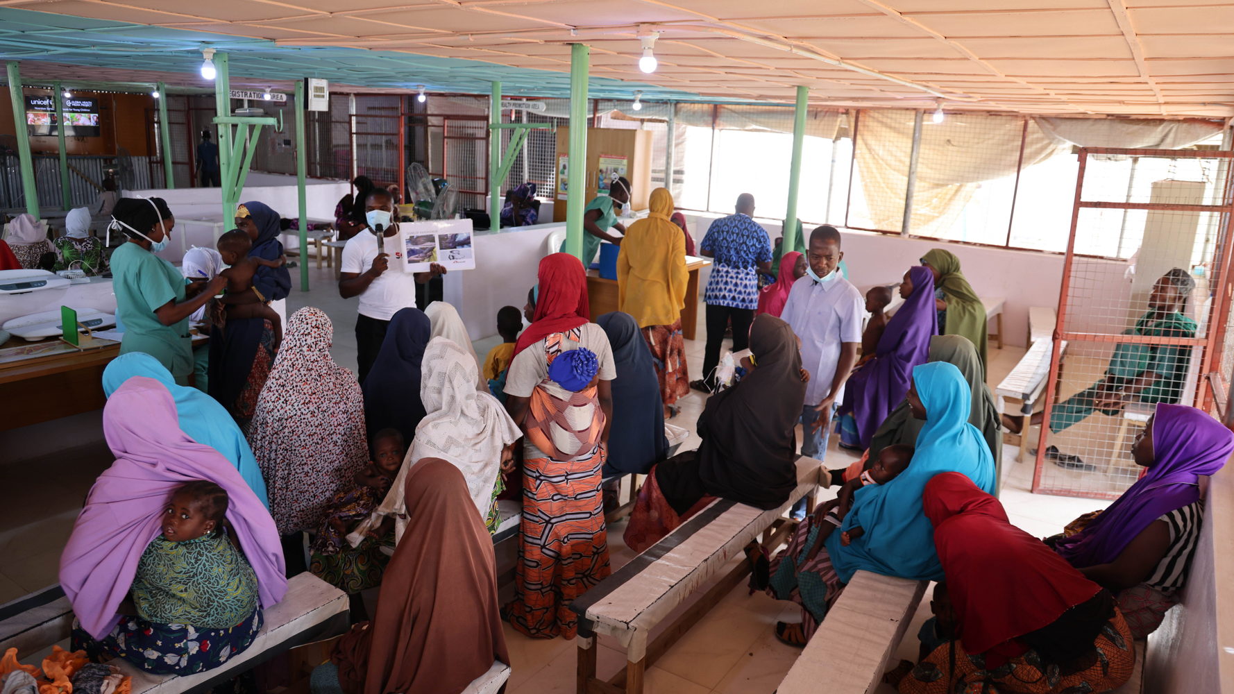 Waiting to be attended to at the triage, the women in this picture listen to an MSF staff who enlightens them on good health seeking practices. Copyright MSF