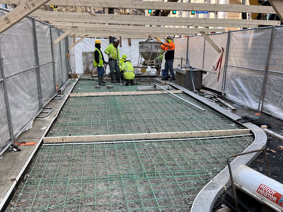 Crews preparing to pour concrete for new sidewalk at Sixth and Fifth avenues Downtown