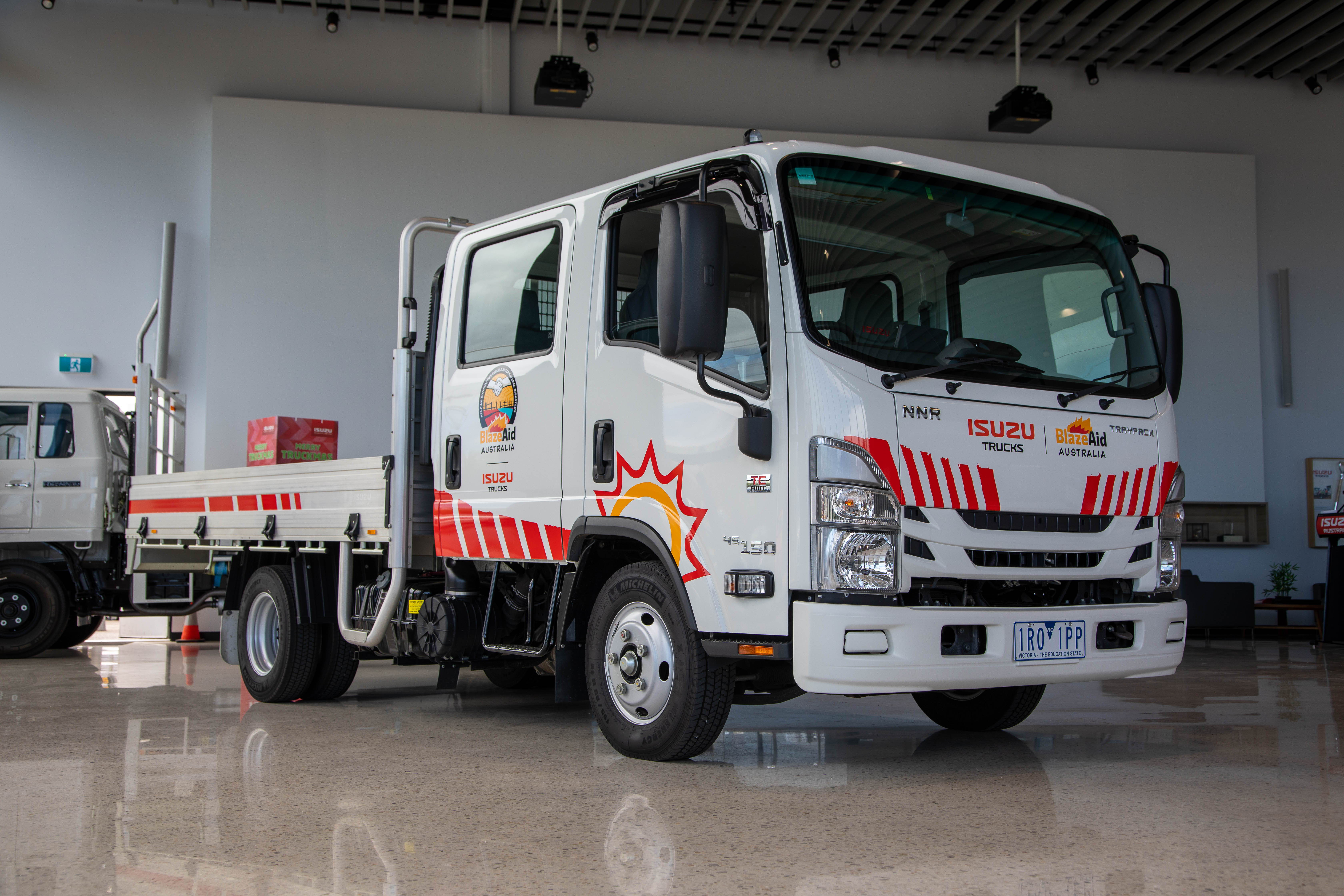 One of the BlazeAid Isuzu Ready-to-Work trucks, the NNR 45-150 AMT Crew Traypack