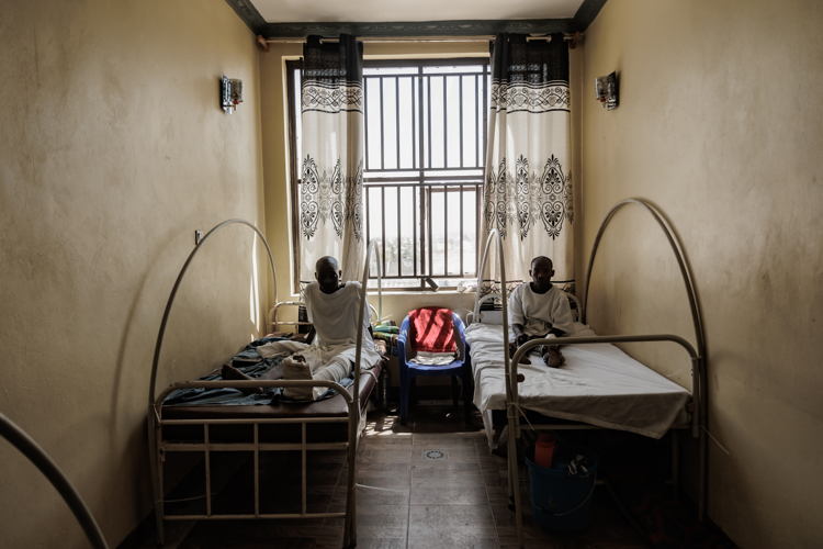 Two patients recovering in a shared room after surgical interventions by MSF teams at Salama Hospital. Ongoing rehabilitation focuses on healing both physical and emotional trauma. Copyright: MSF Two patients recovering in a shared room after surgical interventions by MSF teams at Salama Hospital. Ongoing rehabilitation focuses on healing both physical and emotional trauma. Copyright: MSF