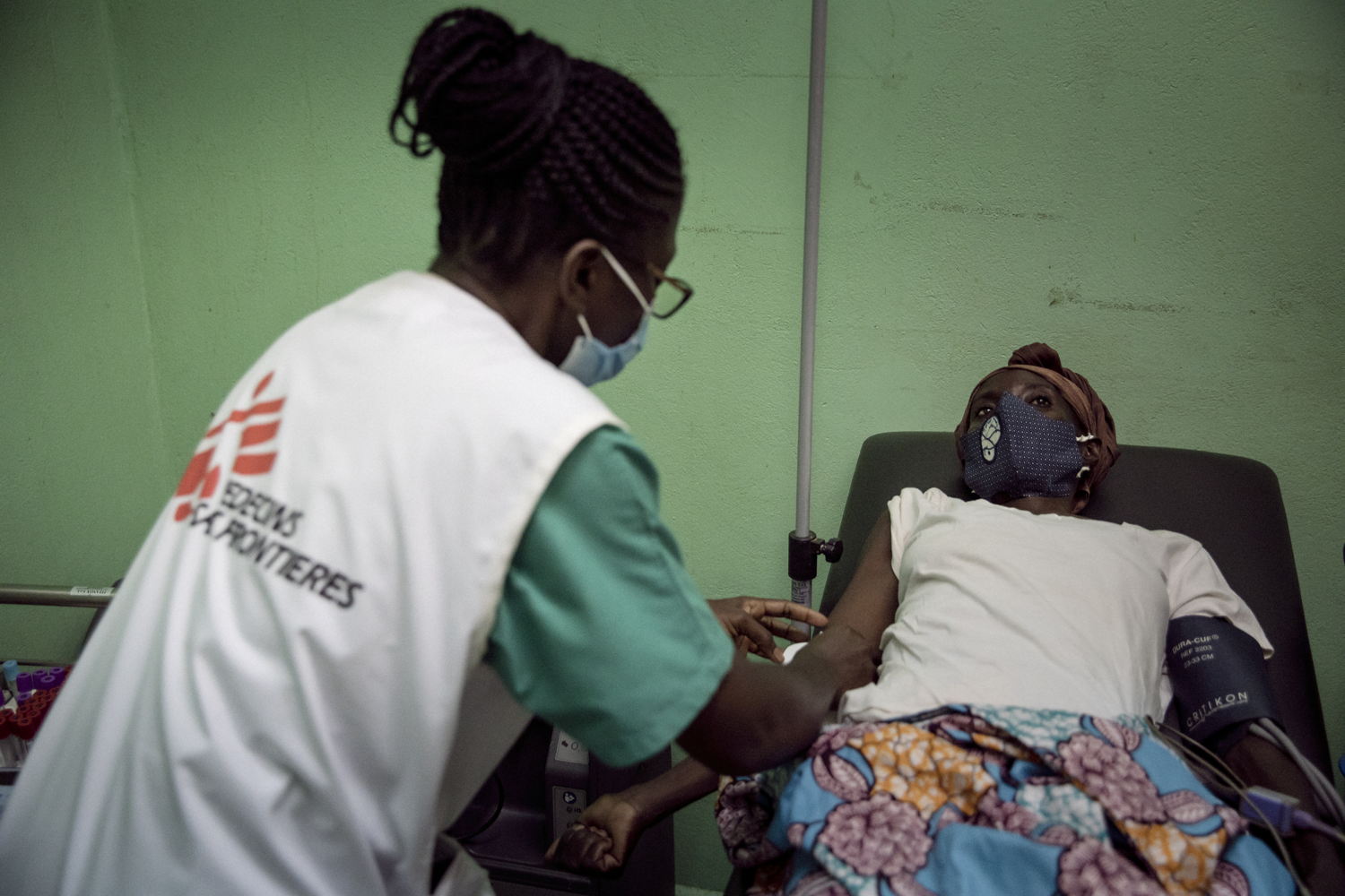 Central African Republic. MSF nurse Josiane Wonzou takes care of patient Edith, 42, in the sorting room of the Centre Hospitalier Universitaire Communautaire (CHUC), where MSF runs the advanced HIV unit. Edith has been having heart palpitations since a week, and has vomited constantly for the last two days. She got scared, as she lives alone, and came to the hospital.  Copyright - Adrienne Surprenant/Collectif Item