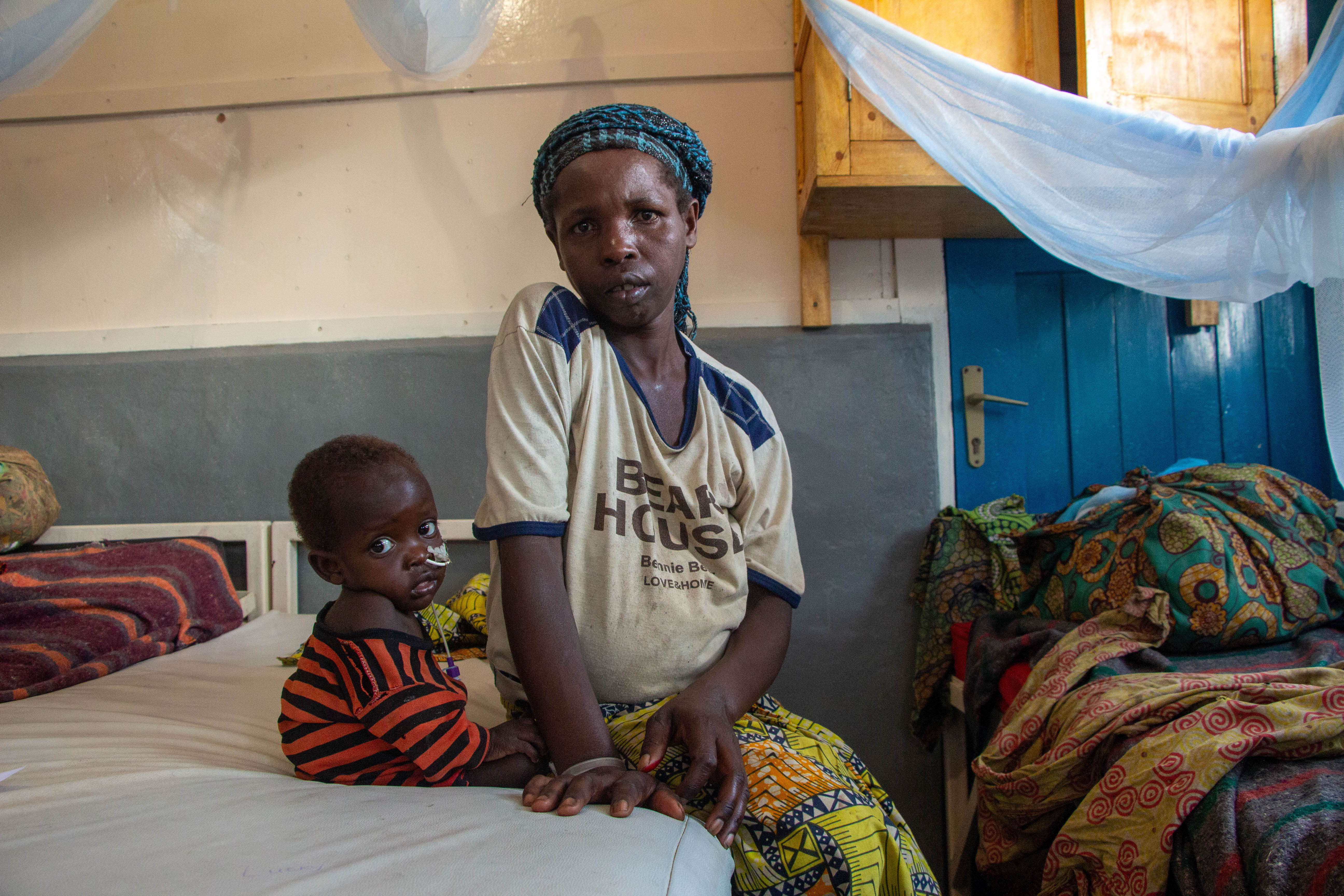 "My first child fell ill, then the second" ​ Feza, 34, took refuge in the forest with her husband and their two children after fleeing fighting between armed groups near their village. Her two children, of 3 and 1 years old, are currently admitted to the intensive care unit of the inpatient therapeutic feeding centre at the Mweso general referral hospital for severe acute malnutrition with complications. Photographer: Laora Vigourt | DRC | 16/08/2023