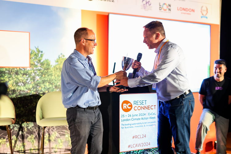 Marc Wetselaar of Smartfill receives the Startup World Cup regional winner trophy in London