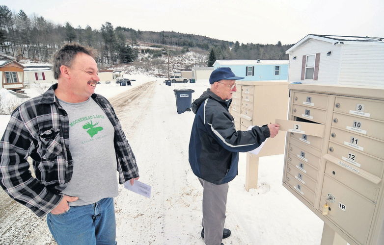 Neighbors Ronald Dickson, left, and Alston Douglass check their mail at Weston’s Mobile Home Park in Berlin, where Dickson has lived two years, and Douglass has resided for 49 years. STEFAN HARD / STAFF FILE PHOTO