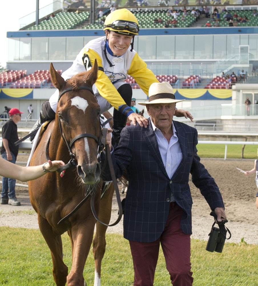 Emma-Jayne Wilson embracing trainer Roger Attfield on the way to the winners circle after winning the  2022 Nassau Stakes (G2) with Lady Shakespeare (Michael Burns Photo)