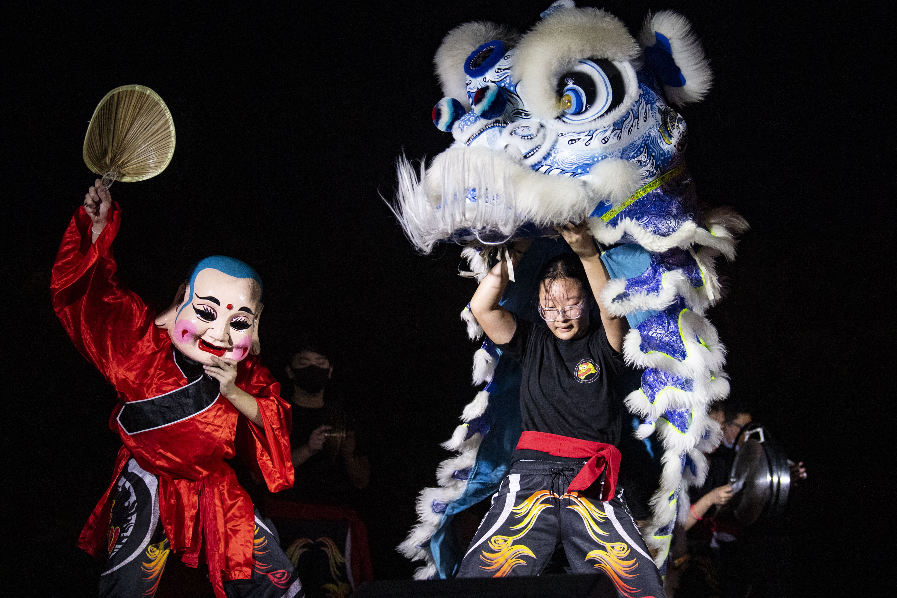 Individuals performing a lion dance.