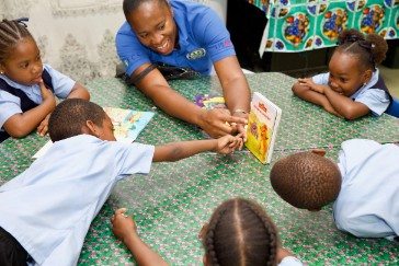 OECS Commission Staff reading to students as part of the USAID/OECS ELP 