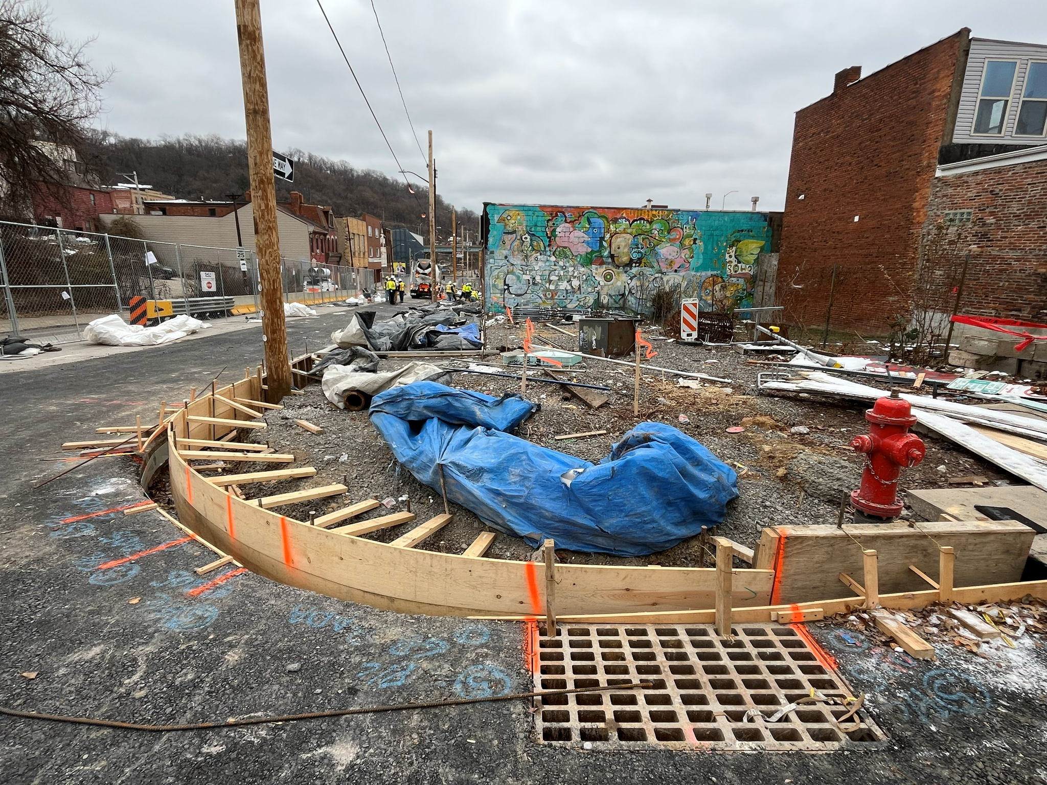 Wood framing recently placed for new sidewalk at Forbes Avenue and Seneca Street