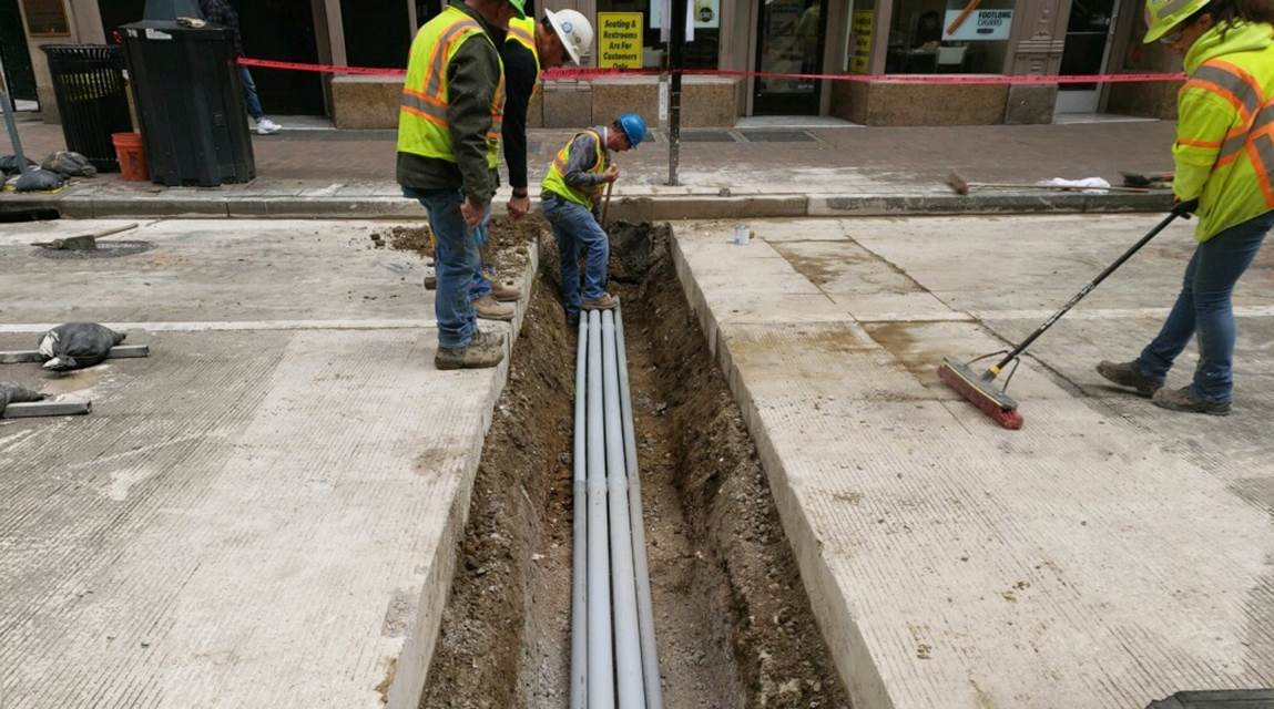 PRT electrical subcontractors placing conduit across Liberty Avenue