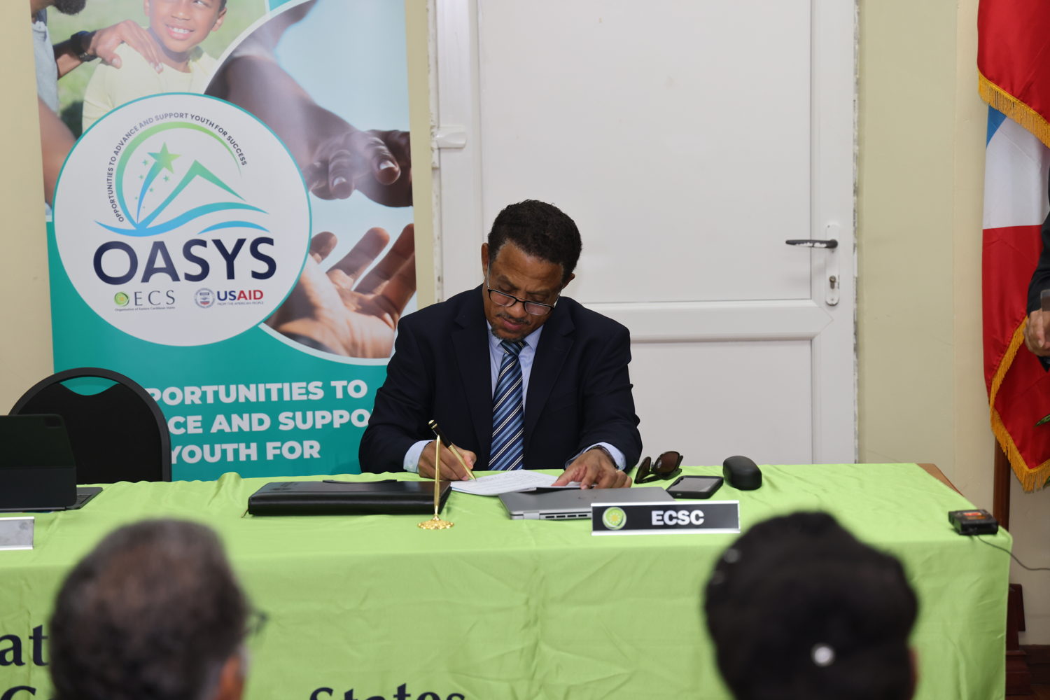 His Lordship, the Honourable Mario Michel-Chief Justice (Ag.), ECSC reviews the Sub-Grant Agreement 