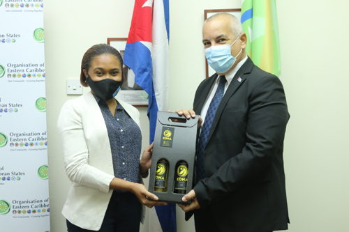 H. E. Alejandro Simancas Marin receives a gift of Saint Lucian wine from youth entrepreneur, Jada Francis