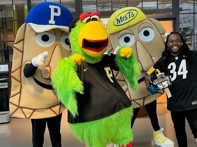 Pittsburgh Pirates mascots from left: Potatoe Pete, Pirate Parrot and Cheese Chester pose with Chef Claudy Pierre after an induction cooking demonstration at the Energy Innovation Center in Pittsburgh's Hill District during DLC's "Powered Up" event on April 22, 2023.