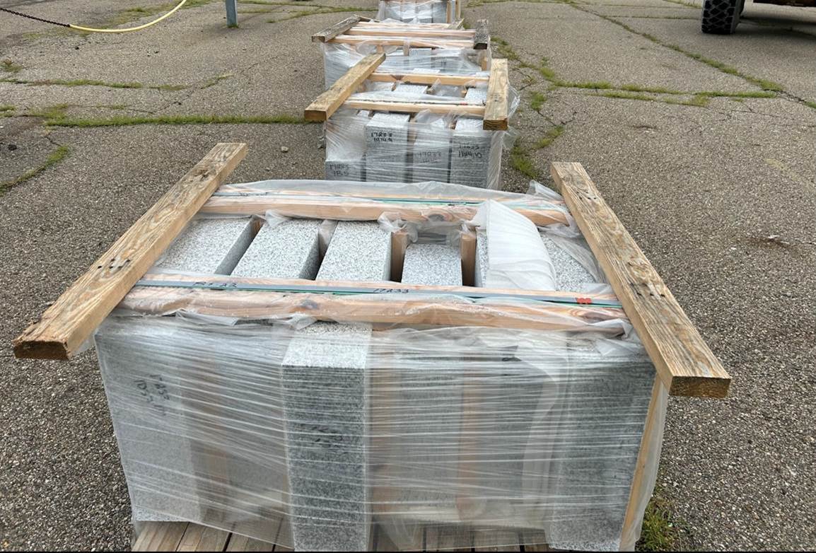 A pallet of granite curb ready for installation