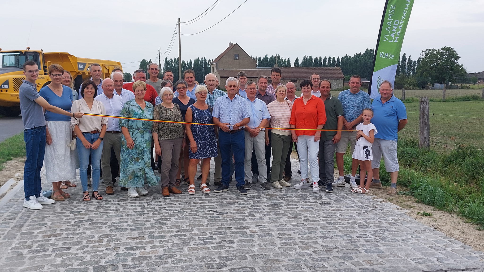 Burgemeester van Alveringem Gerard LIefooghe knipt het lint door om de heraangelegde kasseiweg in te huldigen. Ook bewoners van de Beauvoordestraat, schepenen en leden van het ruilverkavelingscomité zijn van de partij. Burgemeester van Alveringem Gerard LIefooghe knipt het lint door om de heraangelegde kasseiweg in te huldigen. Ook bewoners van de Beauvoordestraat, schepenen en leden van het ruilverkavelingscomité zijn van de partij.